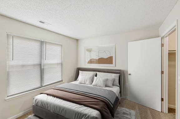 a bedroom with a large window and a large bed