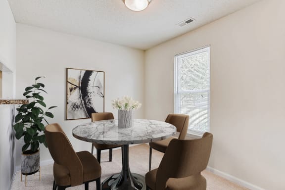 a dining room with a table and chairs