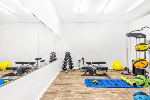 Fitness Center with Exercise Equipment, free weights, and Mirrored Wall