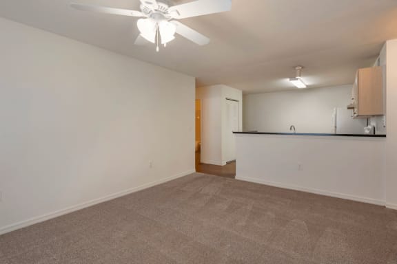 Carpeted Living Room Connected to Breakfast Bar off of Kitchen