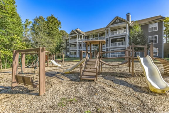 a playground at the enclave at woodbridge apartments in sugar land, tx