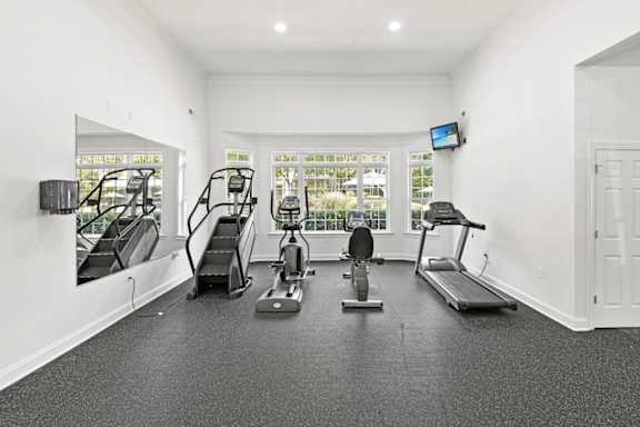 A spacious home gym with a variety of exercise equipment.