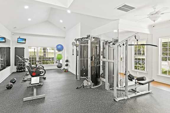 A spacious home gym with a variety of exercise equipment.