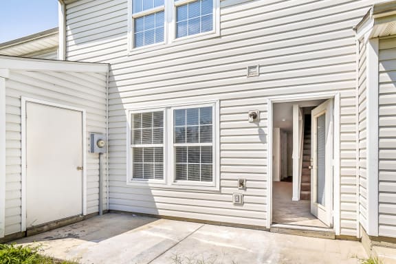 a white house with a white door and white siding