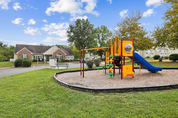 A playground with a blue slide and a yellow structure.