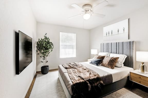 Vacant bedroom with carpet, window, and a ceiling fan.