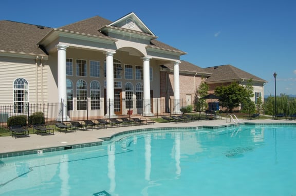 Community Clubhouse and swimming pool with loungers.