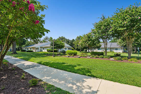 A residential area with houses and a sidewalk.