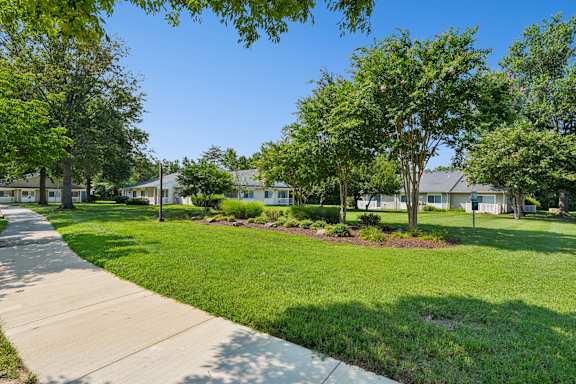 A sunny day in a residential neighborhood with houses and green lawns.