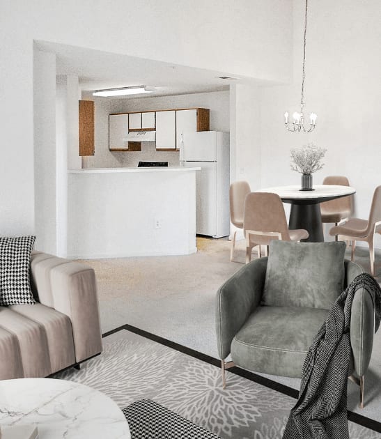 Vacant living room with tan carpet, white walls, and ceilings. The kitchen is in the background with a chandelier hanging over the dining area. Virtually staged with a couch, decorative chair, accent rug and coffee table, with dining table and four chairs in the background under the chandelier.