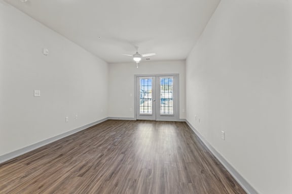 A room with wooden flooring and a window with blinds at Litchford 315 Apartments, North Carolina, 27615