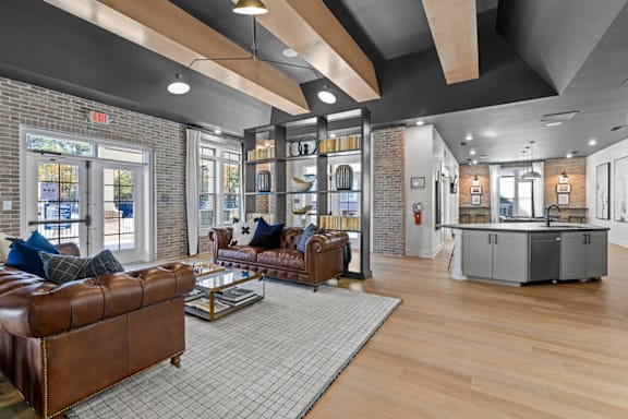 A living room with a brown leather couch and a grey rug at Litchford 315 Apartments, North Carolina, 27615