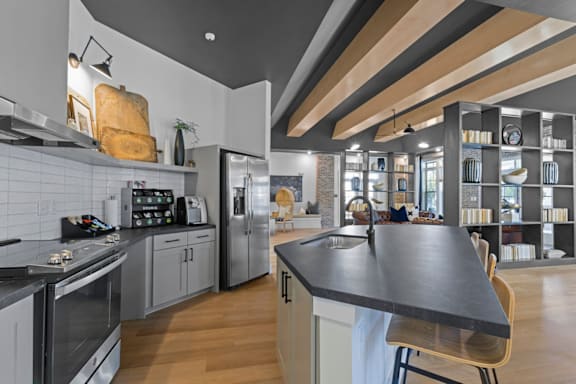 A modern kitchen with a large island in the center at Litchford 315 Apartments, Raleigh, NC, 27615