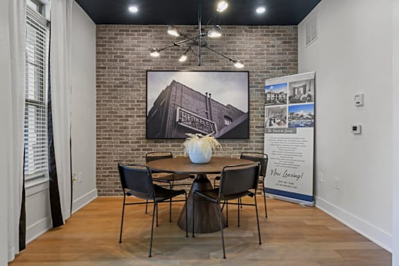 A room with a brick wall and a dining table set up at Litchford 315 Apartments, Raleigh, North Carolina