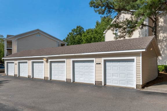 Detached Garages Next to Parking Lot with Trees in the Background