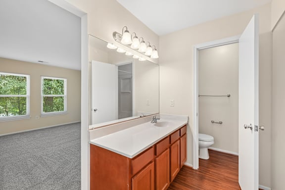 A bathroom with a white sink and a toilet.