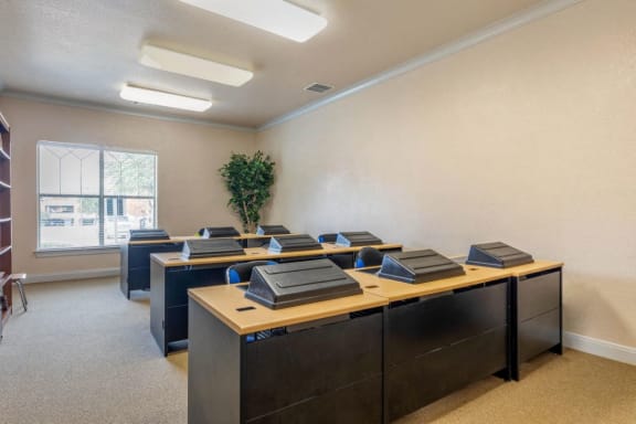 Computer lab with computers, desks, and chairs
