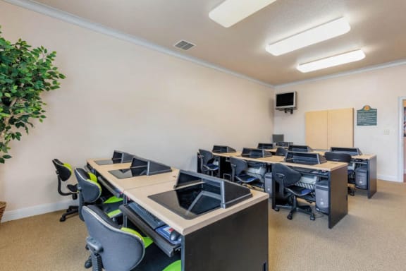 Computer lab with computers, desks, and chairs