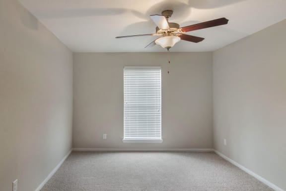 Carpeted Bedroom with Window and Ceiling Fan
