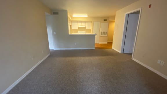 Carpeted Living Room with kitchen/dining room view, dual tone paint