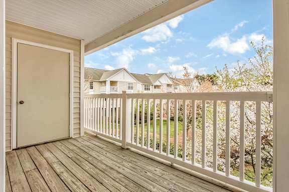 A view from a porch looking out at a residential neighborhood.