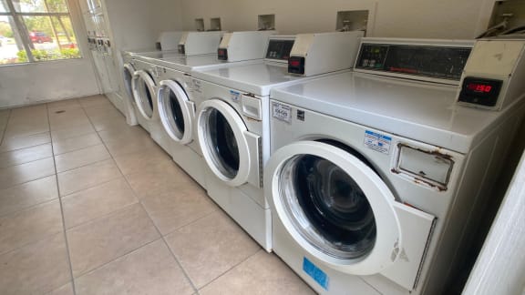 Laundry center with washer and dryers and tile flooring