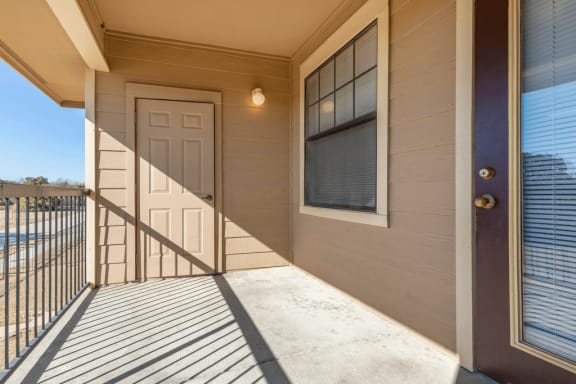 Covered balcony with banister, light and exterior storage closet