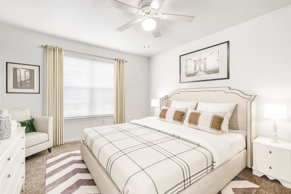 Bedroom with large window and ceiling fan