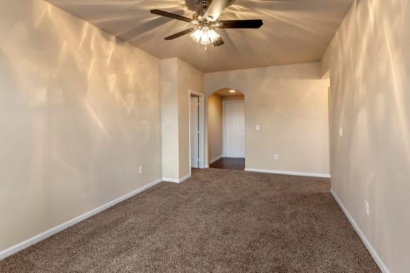 Living room with wall to wall carpet and ceiling fan