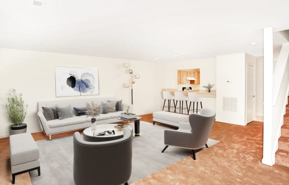 Virtually staged living room interior with grey couch, grey side chairs, and coffee table. Kitchen in background with three grey bar stools