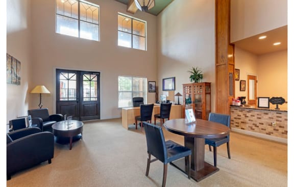 Clubhouse interior with large windows, tables, chairs, and decorations