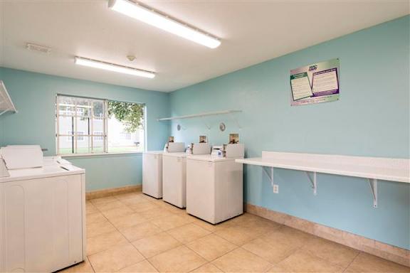 A laundry room with washer and dryer machines.