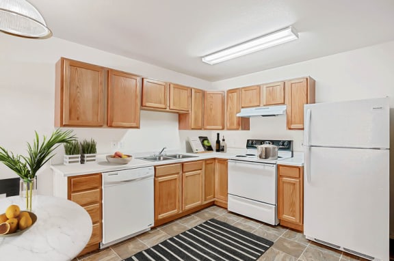 Fully equipped kitchen with oak cabinetry at Rose Cove Homes Apartments, Farmington, UT 84025