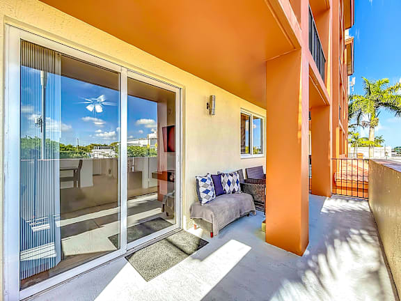 A balcony with a chair and pillows