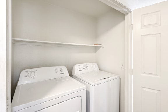 Inunit washer and dryer with overhead shelf at Lake Pleasant Village Apartments, Peoria, AZ 85382