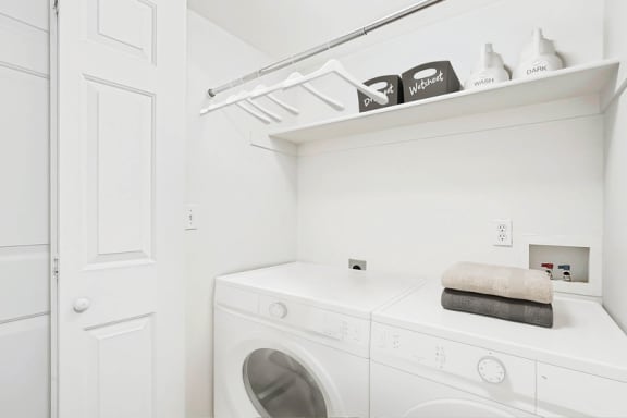 In unit laundry room with upper storage shelf at Rose Cove Homes Apartments, Farmington, 84025