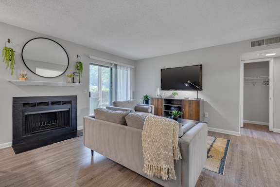 A living room with a fireplace and a couch.