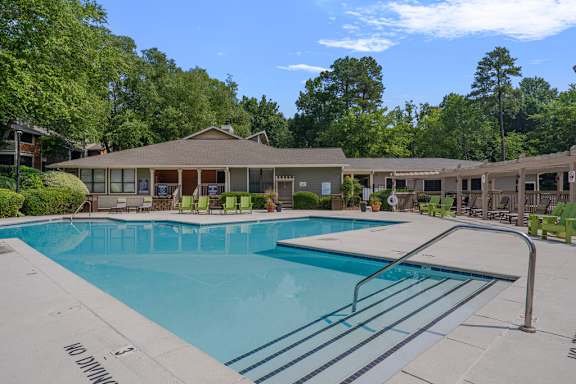 a swimming pool with a building in the background