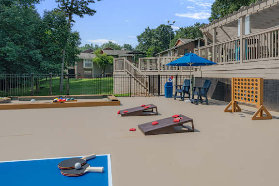 A blue table tennis table is in the foreground of a residential area.