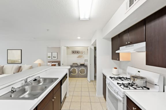a kitchen with white appliances and white countertops