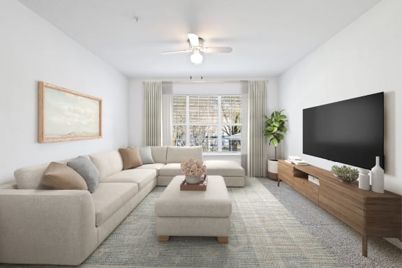 a living room with a large couch and a flat screen tv