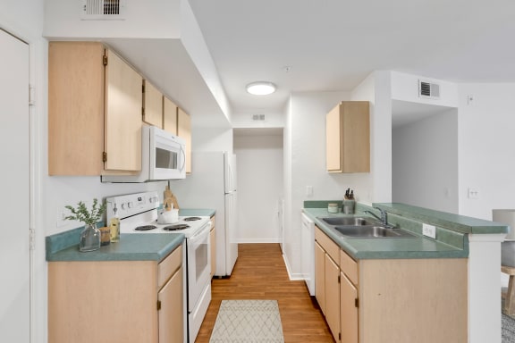 a kitchen with green countertops and white appliances
