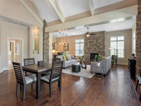 Clubhouse Seating Area with Dining Room Table with Chairs  Grey Couches Triangle Glass Coffee Table Brick Fireplace with Windows and Decorations
