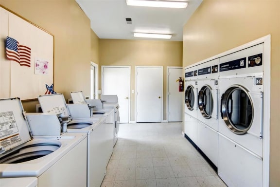 Laundry Facilities with Washers and Dryers and Bulletin Board on the Wall