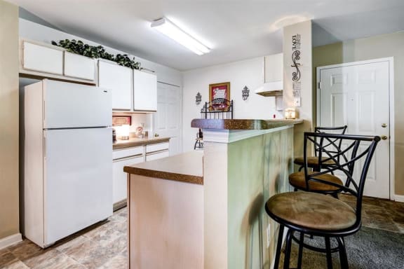Model Kitchen ith White Cabinets and Appliances and Breakfast Bar and Bar Stools
