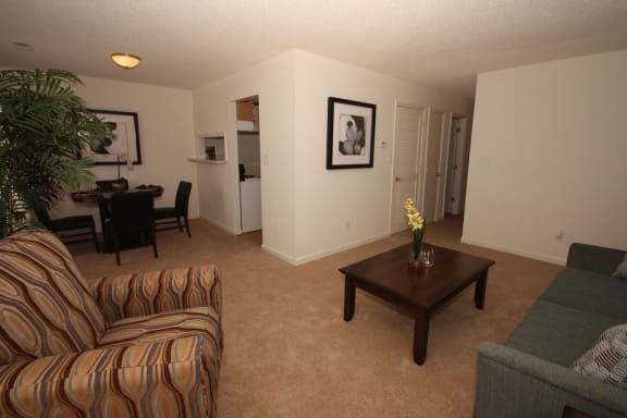 a living room with a couch and a chair and a coffee table