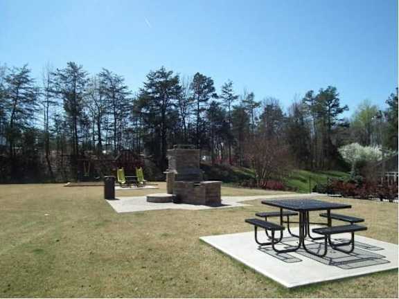 A picnic table is surrounded by a white square with a black border. at Eastchester Ridge Apartments, High Point, North Carolina