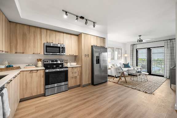 a kitchen and living room with a stove and refrigerator
