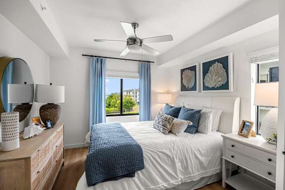 a bedroom with a large bed and a ceiling fan