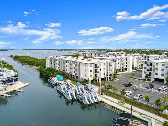 an aerial view of a marina with buildings and boats on the water